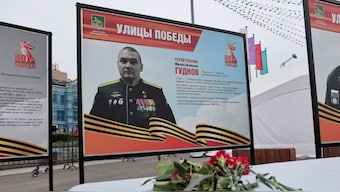 A view shows flowers placed in front of a board with a photograph of Major General Mikhail Gudkov, the deputy head of the Russian Navy who, according to local authorities, was recently killed in the Kursk region amid Russia-Ukraine conflict, at an exhibition of distinguished Russian soldiers' portraits in the far eastern city of Vladivostok, Russia, July 3, 2025. (Reuters/Tatiana Meel)
