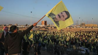 Syrian Kurds hold flags as they gather after Turkey's jailed militant leader Abdullah Ocalan called on his Kurdistan Workers Party (PKK) to lay down its arms on Thursday, a move that could end its 40-year conflict with Ankara and have far-reaching political and security consequences for the region, in Hasakah, Syria February 27, 2025. REUTERS/Orhan Qereman/File Photo