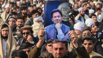 A supporter of jailed former Pakistani Prime Minister Imran Khan holds his poster during a gathering by the Pakistan Tehreek-e-Insaf (PTI) party to observe Martyrs' Day to honour those who allegedly died during last month's protest, in Peshawar on December 15, 2024. (Photo: Abdul Majeed/AFP)