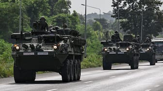 Royal Thai Army soldiers are pictured on armoured vehicles on a road in Chachoengsao province on July 24, 2025. (Photo: Lillian Suwanrumpha/AFP)