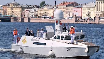 Russian President Vladimir Putin, third from left, stands aboard the Raptor boat during his visit to St. Petersburg on Navy Day, Russia, on Sunday, July 27, 2025. (Alexei Danichev, Sputnik, Kremlin Pool Photo via AP)