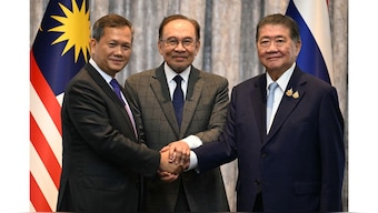 Malaysia's Prime Minister Anwar Ibrahim (C), Cambodia's Prime Minister Hun Manet (L), and Thailand's acting Prime Minister Phumtham Wechayachai (R) pose for photos as they shake hands following a press conference after talks on a possible ceasefire between Thailand and Cambodia in Putrajaya on July 28, 2025. (Photo: Mohd Rasfan/Pool/AFP)