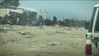 In this screengrab from a video shared by the United Nations (UN), Palestinians are seen sitting as a UN convoy with food supplies approaches them in the Gaza Strip. The UN said Israeli bullets were landing merely inches away from these people. (Photo: UN's Office for the Coordination of Humanitarian Affairs)