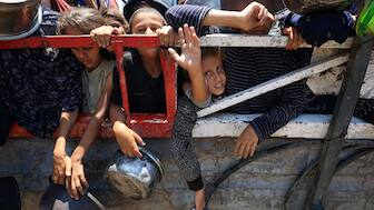 Palestinian children gather to receive food from a charity kitchen, amid a hunger crisis, in Gaza City, July 22, 2025. File Image/Reuters