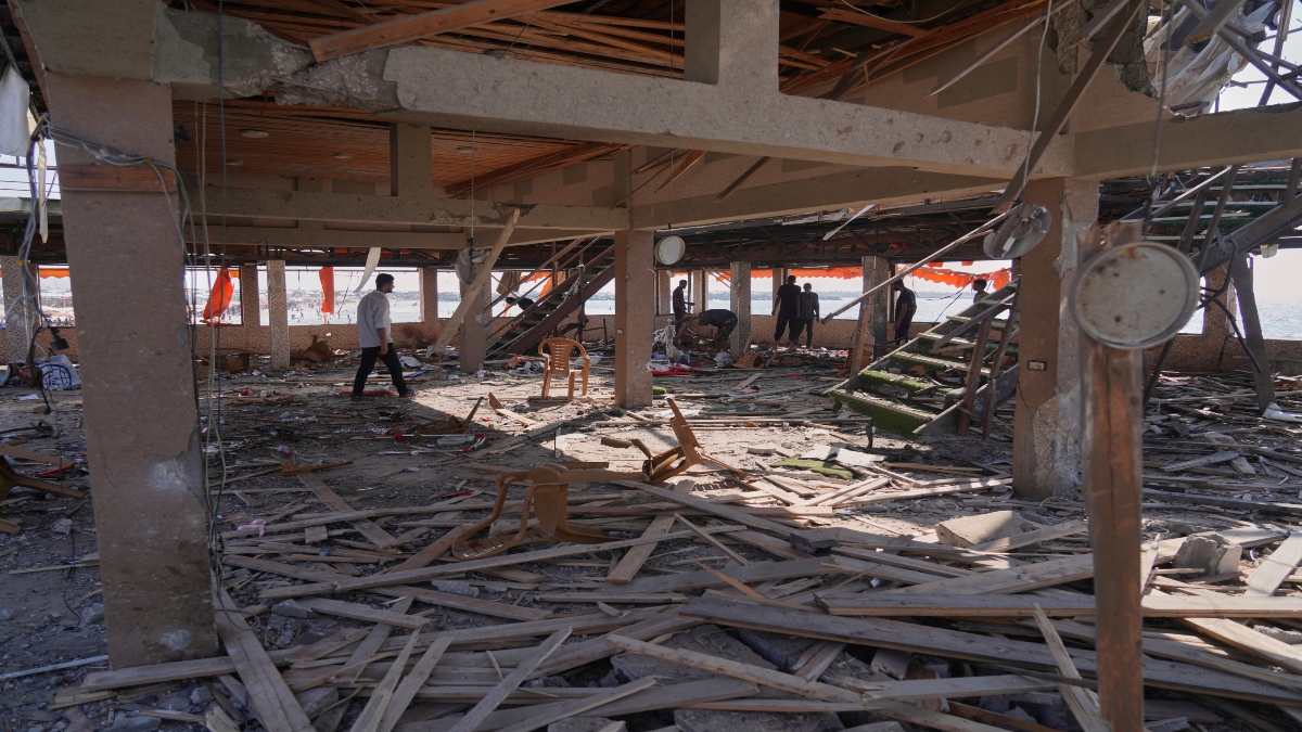 Palestinians check an area of a cafe that was damaged in an Israeli strike in Gaza City on Monday. AP Palestinians check an area of a cafe that was damaged in an Israeli strike in Gaza City on Monday. AP