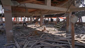 Palestinians check an area of a cafe that was damaged in an Israeli strike in Gaza City on Monday. AP