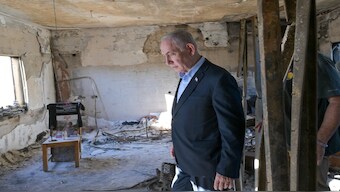 Israel's Prime Minister Benjamin Netanyahu looks at the devastation caused in Kibbutz Niz Oz in the October 7 attack. X / @IsraeliPM_heb