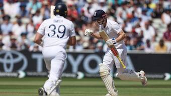 England's Harry Brook, right, celebrates after scoring a century on day three of the second cricket test match between England and India at Edgbaston. AP