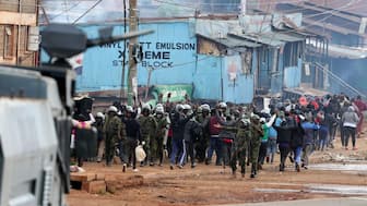 Protesters raise their hands next to riot police officers during the "Saba Saba People's March" anti-government protest, in Kangemi area of Nairobi, Kenya, July 7, 2025. File Image/Reuters