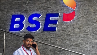 A man passes by a BSE logo inside the Bombay Stock Exchange building, in Mumbai. File Image/PTI