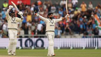 Ravindra Jadeja celebrates after completing his century while Washington Sundar applauds his teammate on Day 5 of the fourth Test between India and England in Manchester. Reuters