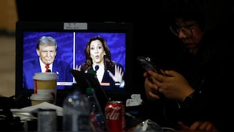 A member of the media uses phone as a screen displays the presidential debate, as Republican presidential nominee, former US President Donald Trump and Democratic presidential nominee, US Vice President Kamala Harris attend a presidential debate hosted by ABC in Philadelphia, Pennsylvania, US, September 10, 2024. File Image/Reuters
