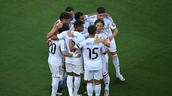 Real Madrid players celebrating a goal. AFP