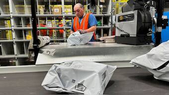 A person works at the Amazon warehouse, busy on Prime Day, in Melville, New York, US. Reuters file