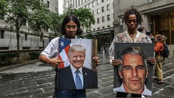 A protest group called "Hot Mess" hold up signs of Jeffrey Epstein and President Donald Trump in front of the Federal courthouse on July 8, 2019 in New York City. File Photo/AFP