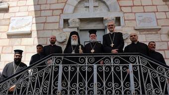 Archbishop Alexios of the Saint Porphyrius Church (C) receives Latin Patriarch of Jerusalem Pierbattista Pizzaballa (3rd-R) and Greek Orthodox Patriarch of Jerusalem Theophilos III (4th-L) during their visit to the Saint Porphyrius Church in Gaza City on July 18, 2025. AFP