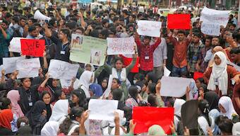 Students shout slogans during a protest near the site of the Monday crash of a Bangladesh air force training jet into a school, demanding accountability, compensation for victims' families and the halt of training flights, in Dhaka, Bangladesh, Tuesday, July 22, 2025. AP