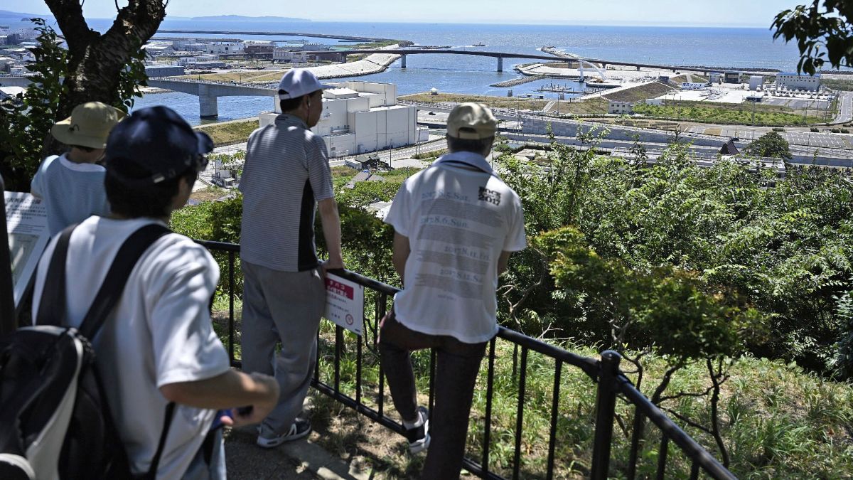 People who evacuated to Hiyoriyama mountain watch toward the sea in Ishinomaki, Miyagi prefecture, northern Japan. AP People who evacuated to Hiyoriyama mountain watch toward the sea in Ishinomaki, Miyagi prefecture, northern Japan. AP