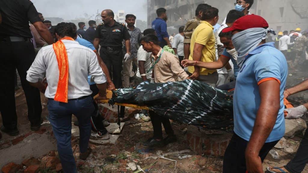 People carry the body of a victim from the crash site after an Air India Boeing 787 Dreamliner plane crashed in Ahmedabad. File image/Reuters