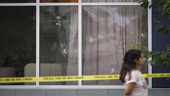 Bullet holes are seen in the windows of Kapil Sharma's Kap Cafe, in Surrey, British Columbia on Thursday, July 10. The Canadian Press/AP