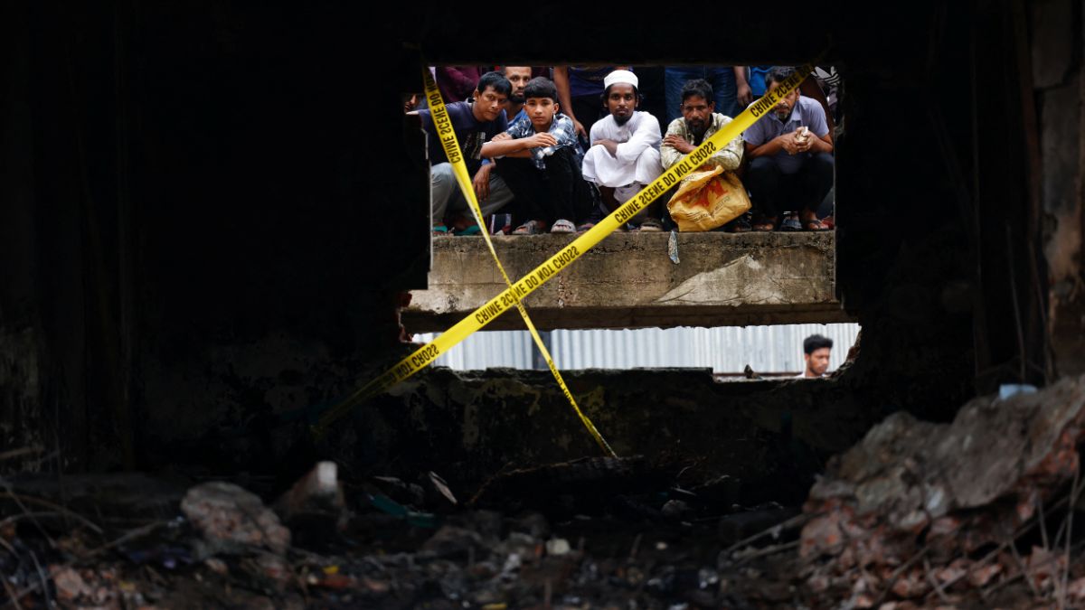 On lookers watch the site through a damaged window, after an air force training aircraft crashed into a building belong to Milestone School and College campus, in Dhaka, Bangladesh, July 22, 2025. Reuters On lookers watch the site through a damaged window, after an air force training aircraft crashed into a building belong to Milestone School and College campus, in Dhaka, Bangladesh, July 22, 2025. Reuters