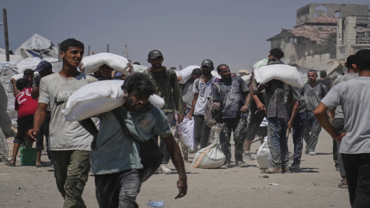 Palestinians carry sacks of flour unloaded from a humanitarian aid convoy that reached Gaza City from the northern Gaza Strip, Sunday, July 27, 2025. AP Palestinians carry sacks of flour unloaded from a humanitarian aid convoy that reached Gaza City from the northern Gaza Strip, Sunday, July 27, 2025. AP