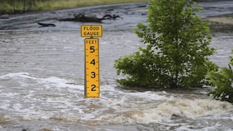 A flood gauge marks the height of water flowing over a farm-to-market road near Kerrville, Texas, on Friday, July 4, 2025. AP