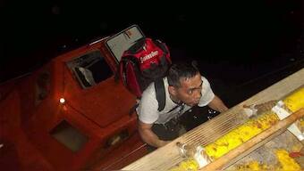 A member of the Greek owned, Liberian-flagged Magic Seas ship climbs on board a rescue boat after an attack claimed by Yemen’s Houthis forced them to abandon the ship. Photograph: UAE's Ministry of Foreign Affairs and International Cooperation