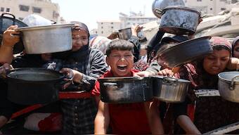 Palestinians crowd at a lentil soup distribution point in Gaza City in the northern Gaza Strip. AFP