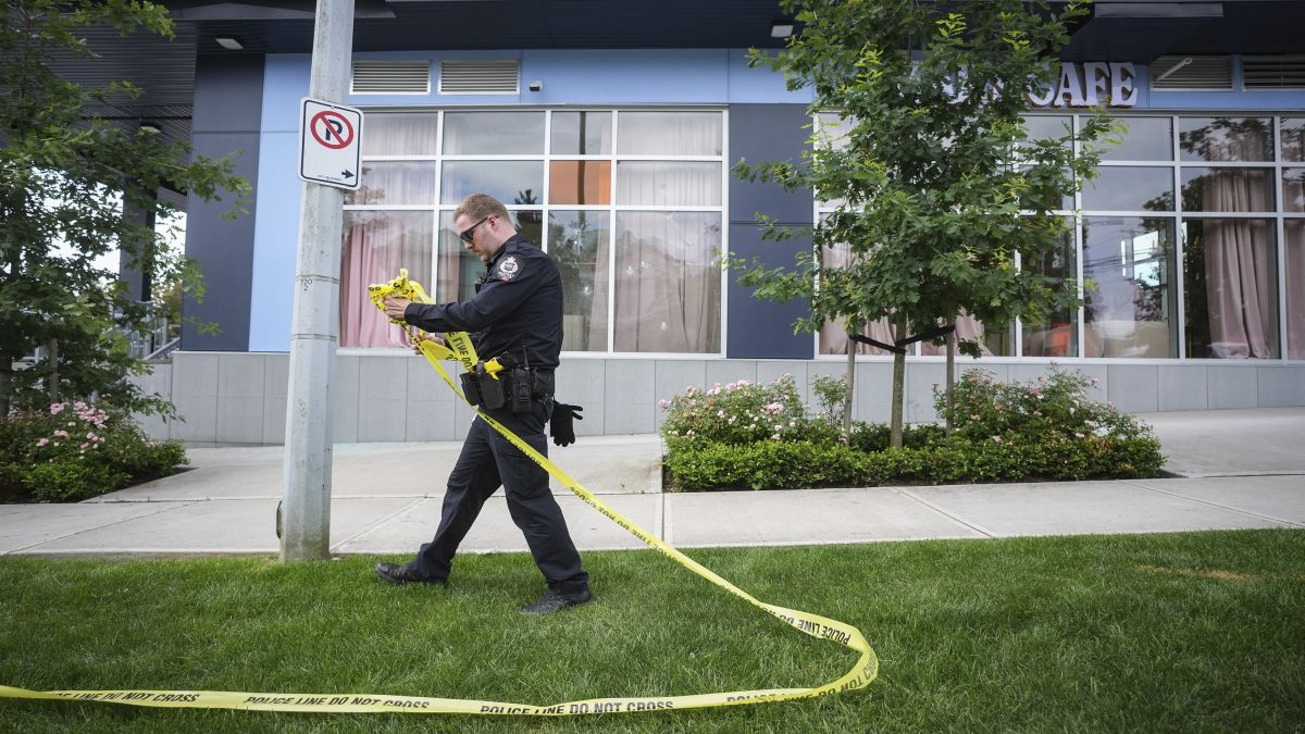 A police officer takes down crime scene tape outside the Kapil Sharma-owned cafe that was shot at multiple times, in Surrey, British Columbia, Thursday, July 10. Surrey Police investigate shots that were fired at Kap's Cafe. The Canadian Press via AP A police officer takes down crime scene tape outside the Kapil Sharma-owned cafe that was shot at multiple times, in Surrey, British Columbia, Thursday, July 10. Surrey Police investigate shots that were fired at Kap's Cafe. The Canadian Press via AP