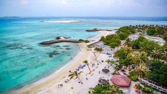 Tourists visit a beach at Maafushi island in the Maldives. File image/AFP