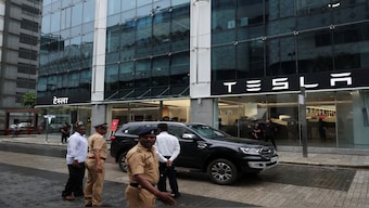 Police officers direct traffic outside the Tesla showroom ahead of its opening in Mumbai. Reuters