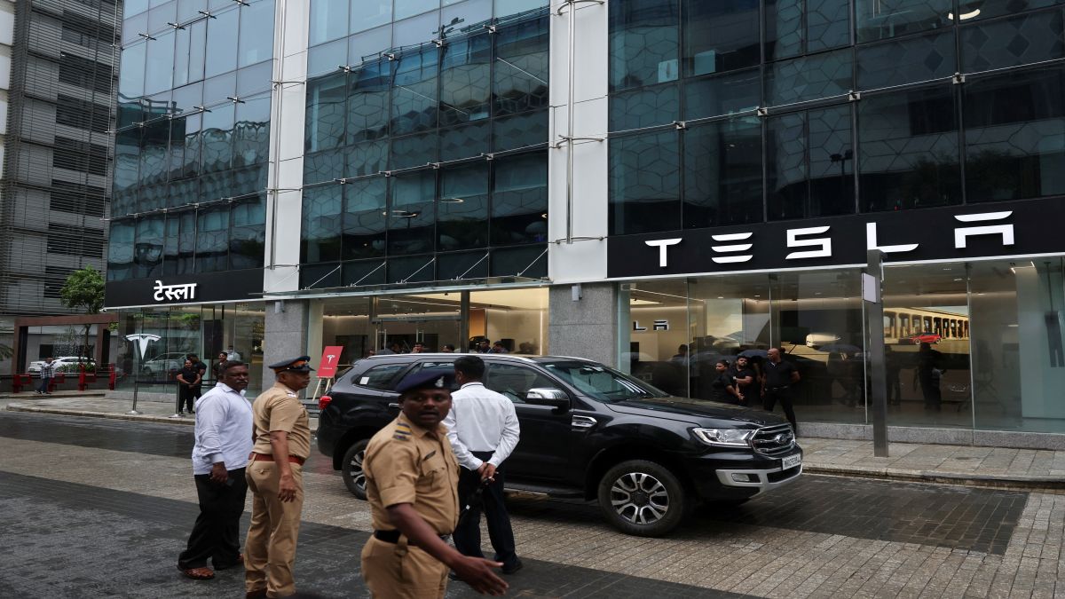 Police officers direct traffic outside the Tesla showroom ahead of its opening in Mumbai. Reuters Police officers direct traffic outside the Tesla showroom ahead of its opening in Mumbai. Reuters