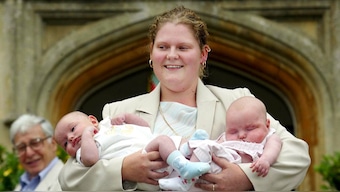 The world's first 'test tube baby' Britain's Louise Brown, faces the media holding 13 week old twins Antonia and Henry Veary, as Professor Robert Edwards (L) looks on, during 25th anniversary celebrations of the revolutionary fertility treatment 'In Vitro Fertilisation' (IVF) at Bourne Hall in Cambridgeshire, UK, July 26, 2003. File Image/Reuters