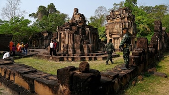 A Thai soldier stands guard as Cambodian people visit the disputed ancient Khmer temple Prasat Ta Muen Thom, or Prasat Ta Moan Thom in Khmer, on the Cambodian-Thai border in Oddar Meanchey province. The temple was at the heart of Thursday's clashes. File image/AFP