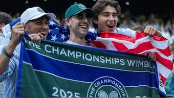 Fans celebrate getting a towel from American player Ben Shelton. Image: Reuters