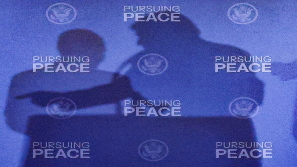 The shadows of the two leaders are cast on a wall behind their podiums. Reuters The shadows of the two leaders are cast on a wall behind their podiums. Reuters