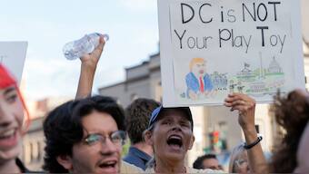 Crowds gathered to protest Trump’s actions in Washington, DC. AP
