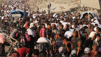 Palestinians carry aid supplies that entered Gaza through Israel, in Beit Lahia in the northern Gaza Strip. Reuters
