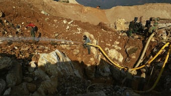 Men use a water cannon to search for rubies at the open pit of a ruby mine in Mogok. Reuters