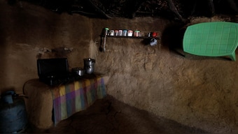 Cooking utensils sit on a side in a kitchen of a house built of mud and stone with roofed with wicker and thatch, in Oued al-Berber, Tunisia. Reuters