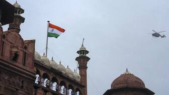 A military helicopter approaches to shower flower petals after the national flag was unfurled at the rampart of the Red Fort, during rehearsal for Independence Day celebrations, in New Delhi. PTI
