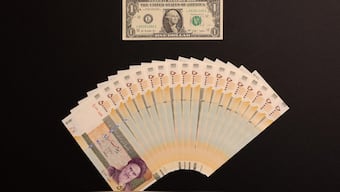 A US one dollar bill and Iranian rials are displayed. Reuters