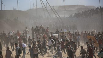 Palestinians carry aid supplies which they received from the US-backed Gaza Humanitarian Foundation, in the central Gaza Strip. File image/ Reuters