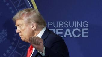 US President Donald Trump gestures as he walks off stage following a press conference with Russian President Vladimir Putin. Reuters