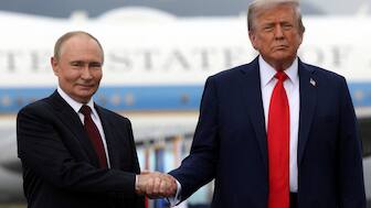 Russian President Vladimir Putin and US President Donald Trump pose on a podium on the tarmac after they arrived to attend a meeting at Joint Base Elmendorf-Richardson in Anchorage, Alaska, US. Reuters