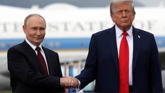 Russian President Vladimir Putin and US President Donald Trump pose on a podium on the tarmac after they arrived to attend a meeting at Joint Base Elmendorf-Richardson in Anchorage, Alaska, US. Reuters