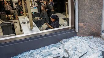 People visit a beauty salon, which was damaged early this morning in a Russian missile and drone strike, as shattered glass lies outside the window, amid Russia's attack on Ukraine, in Kyiv, Ukraine, August 28, 2025. Reuters