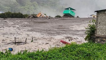 Houses and other buildings collapsed like a deck of cards and were swept away. PTI
