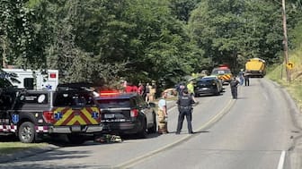 Emergency personnel work at the site of the crash on 23 August 2025. AP